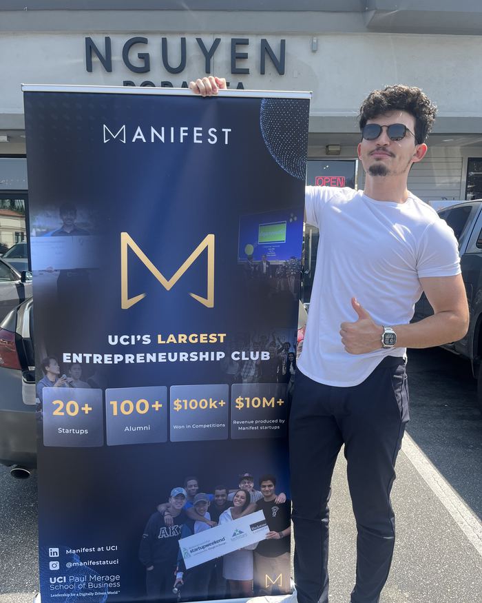 Connor Ruffalo holding a Manifest banner
