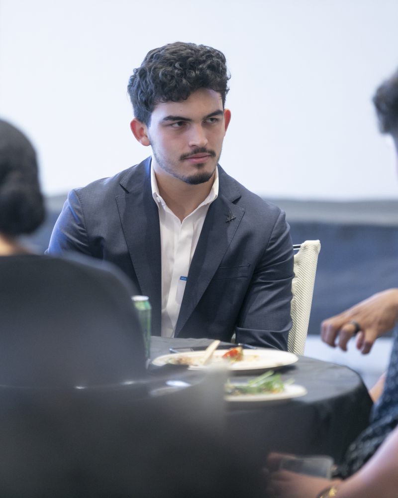 Connor Ruffalo in conversation at a networking table